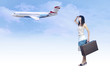 Young woman on the vintage baggage wait on the flying