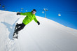 Snowboarder on pise in high mountains