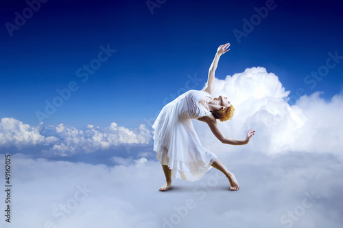 Photo: Ballerina seating on the sky clouds Ballerina seating on the sky clouds