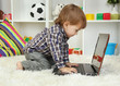 cute little boy and notebook in room