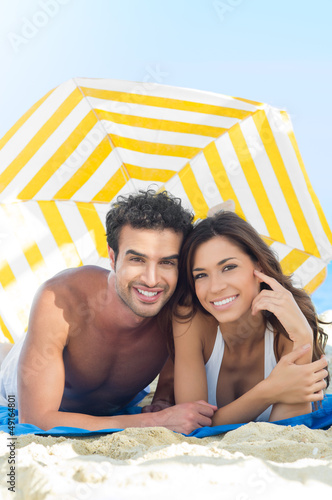 Photo: Smiling Couple Enjoying At Beach Smiling Couple Enjoying At Beach