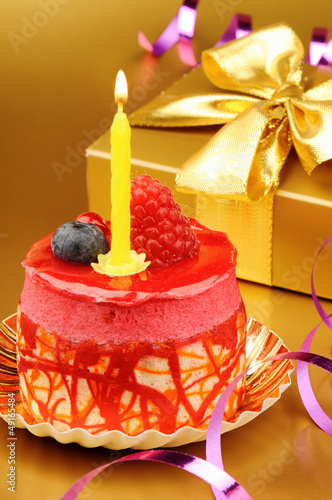 Photo: Colorful birthday cake with candle Colorful birthday cake with candle