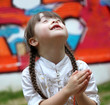 Portrait of beautiful young girl praying