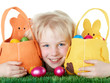 Cute blonde child is happy to found her Easter baskets