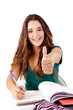 Photo: Portrait of a young happy student doing thumbs up Portrait of a young happy student doing thumbs up