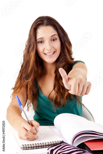 Photo: Portrait of a young happy student doing thumbs up Portrait of a young happy student doing thumbs up