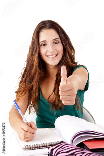 Photo: Portrait of a young happy student doing thumbs up Portrait of a young happy student doing thumbs up