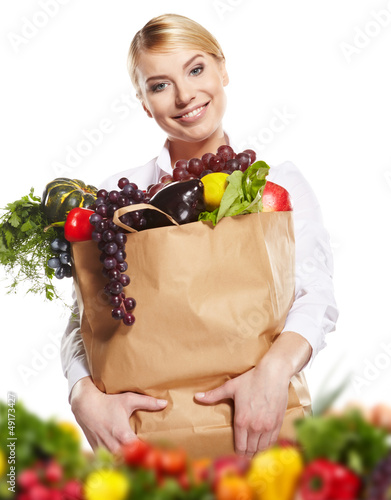 Photo: Young woman with a grocery shopping bag. Isolated on white backg Young woman with a grocery shopping bag. Isolated on white backg