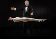 Portrait of professional hypnotist on black background working w