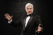 Portrait of professional hypnotist on black background