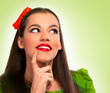 Portrait of a beautiful woman in green thinking
