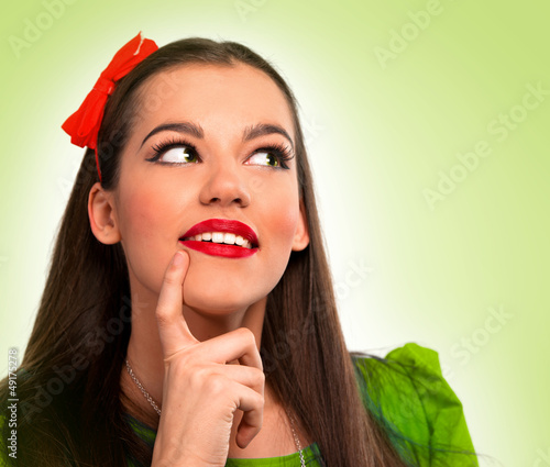 Photo: Portrait of a beautiful woman in green thinking Portrait of a beautiful woman in green thinking