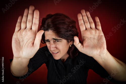 Photo: Frightened woman defending herself Frightened woman defending herself