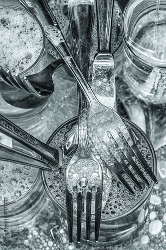 Photo: Cutlery being washed with water and detergent Cutlery being washed with water and detergent