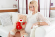 pregnant girl hugging a teddy bear