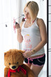 pregnant girl hugging a teddy bear