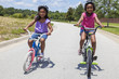 Photo: Happy African American Girls Riding Bikes Happy African American Girls Riding Bikes