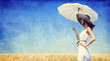 Photo: Women with umbrella at wheat field. Women with umbrella at wheat field.