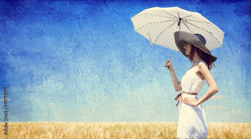 Photo: Women with umbrella at wheat field. Women with umbrella at wheat field.