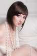 Tempting woman in white lingerie with beads