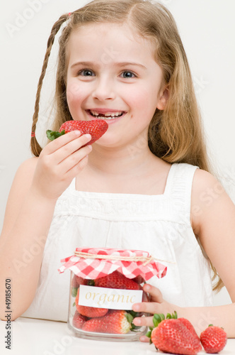 Photo: Strawberry time - lovely girl eating strawberries Strawberry time - lovely girl eating strawberries