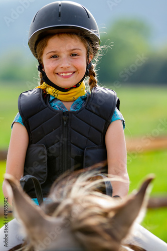 Photo: Horse riding - portrait of lovely equestrian on a horse Horse riding - portrait of lovely equestrian on a horse