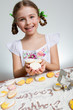Photo: Happy Easter - lovely girl making easter cookies Happy Easter - lovely girl making easter cookies