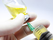 Photo: Syringe in hand and in vial Syringe in hand and in vial