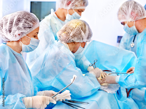 Photo: Surgeon at work in operating room. Surgeon at work in operating room.