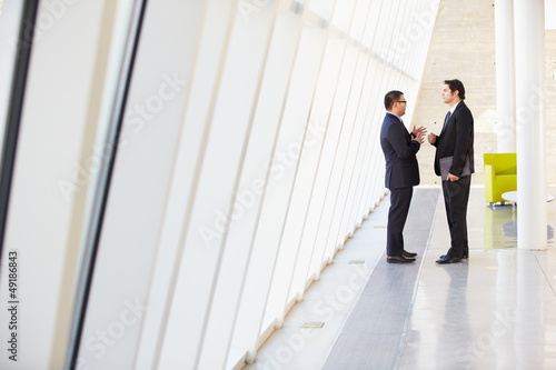 Photo: Two Businessmen Having Informal Meeting In Modern Office Two Businessmen Having Informal Meeting In Modern Office