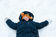 Foto: Little boy playing snow angels Little boy playing snow angels