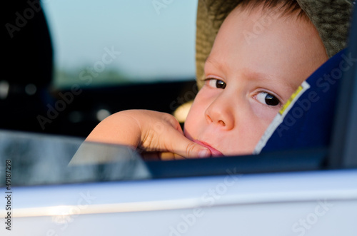 Photo: Bored little boy in a car Bored little boy in a car