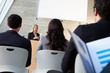 Businesswoman Delivering Presentation At Conference