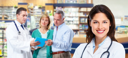 Photo: Pharmacist with a senior couple. Pharmacist with a senior couple.