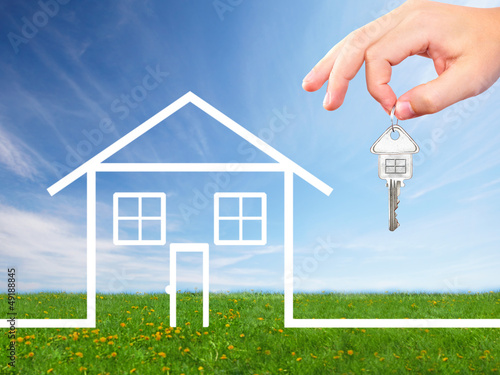 Photo: Hand with a house key. Hand with a house key.