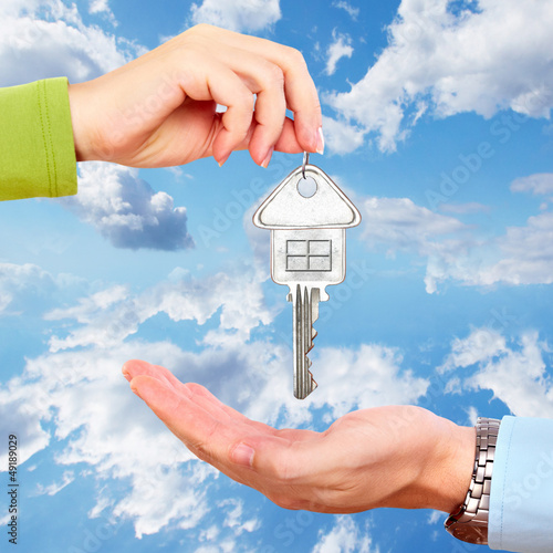 Photo: Hand with a house key. Hand with a house key.