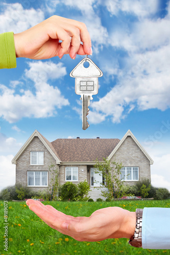 Photo: Hand with a house key. Hand with a house key.