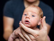 Newborn baby on the fathers hands