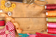 Sewing accessories and fabric on wooden table close-up