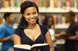 happy female african american college student in library