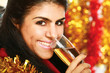 Beautiful young  woman drinking champagne at christmas party.