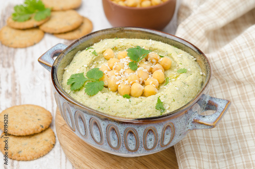Photo: Hummus with cilantro and crackers, horizontal Hummus with cilantro and crackers, horizontal