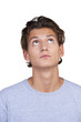 Wide-eyed young guy looking upwards against a white background