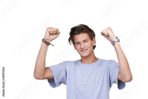 Photo: Handsome young guy clenching both his fists in a positive gestur Handsome young guy clenching both his fists in a positive gestur