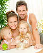 Young happy family with a pet rabbit
