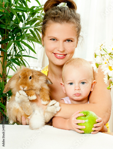 Photo: young mother,baby and their pet rabbit young mother,baby and their pet rabbit