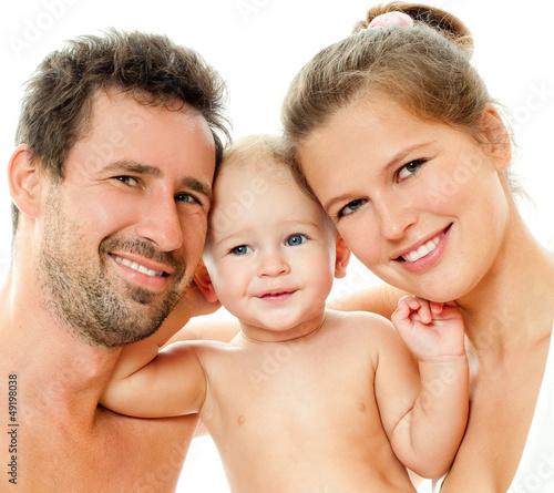 Photo: Happy young family with baby. Indoors. Happy young family with baby. Indoors.
