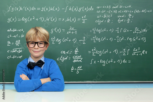 Photo: Schoolboy at the Blackboard with Formulas Schoolboy at the Blackboard with Formulas