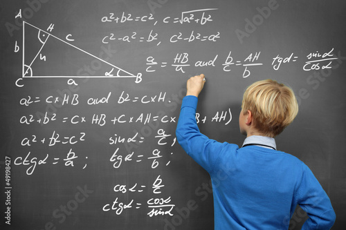 Photo: Schoolboy at the Blackboard with Formulas Schoolboy at the Blackboard with Formulas