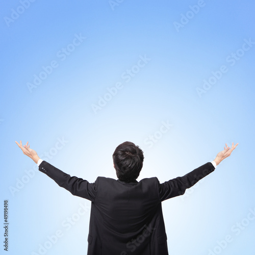 Photo: back view of business man arms up back view of business man arms up